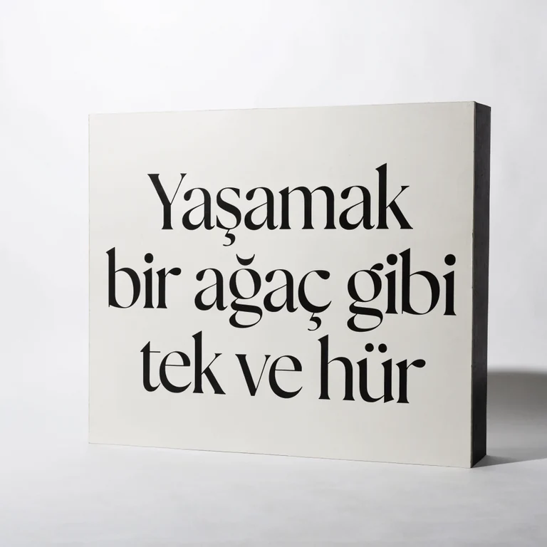 Generated image intended to read Yaşamak bir ağaç gibi tek ve hür